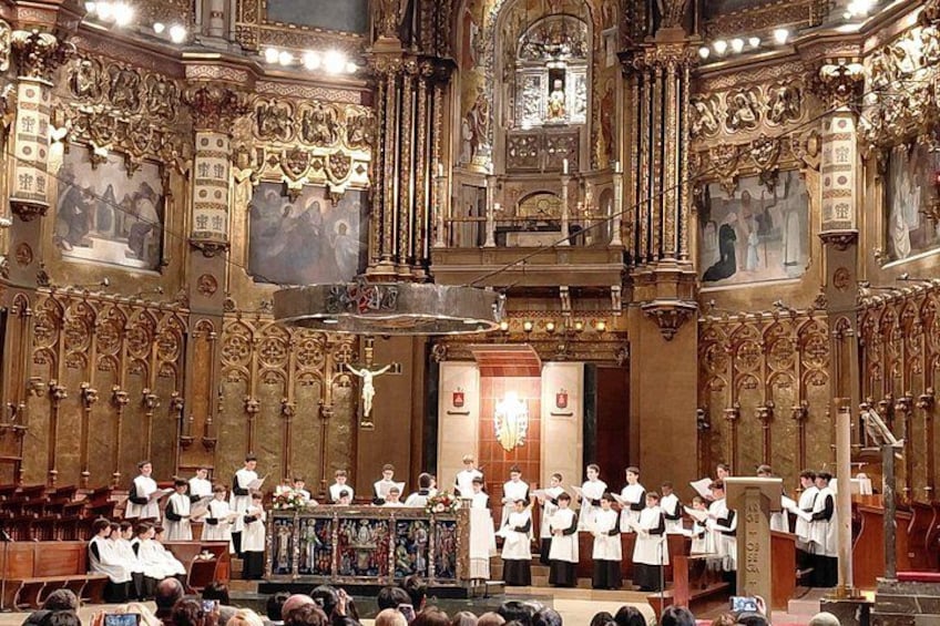 A choir performing in a grand, ornately decorated church with intricate woodwork and religious paintings. 2