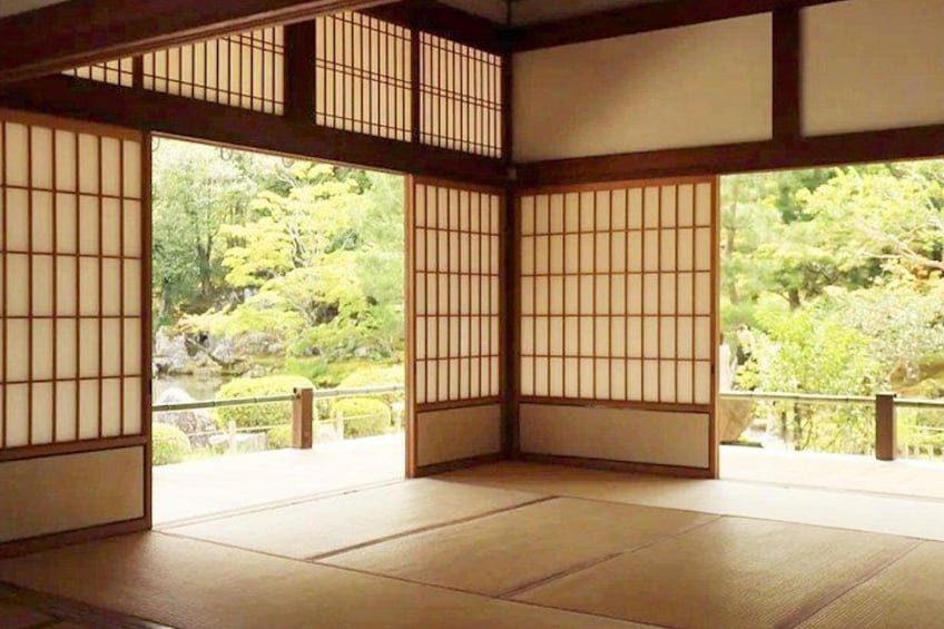 A traditional Japanese room with tatami flooring and shoji screens. 2