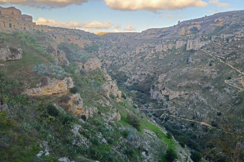 A rugged canyon landscape with rocky terrain and a winding road. 2