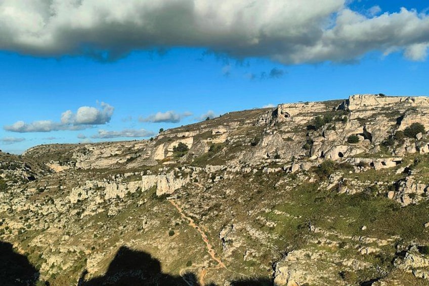 A rugged mountainous landscape with rocky outcrops and sparse vegetation. 4