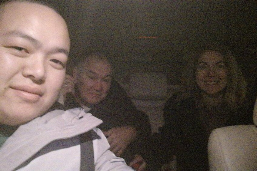 A group of people seated in a vehicle. 2