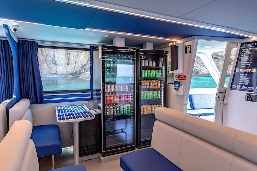 A train interior with seating, a table, and beverage dispensers. 3
