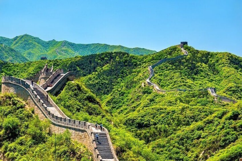 The Great Wall of China winding through lush green hills. 3