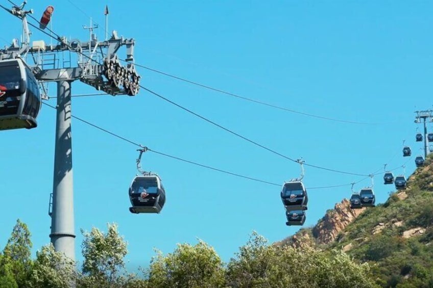 A cable car system with gondolas ascending a mountain. 2