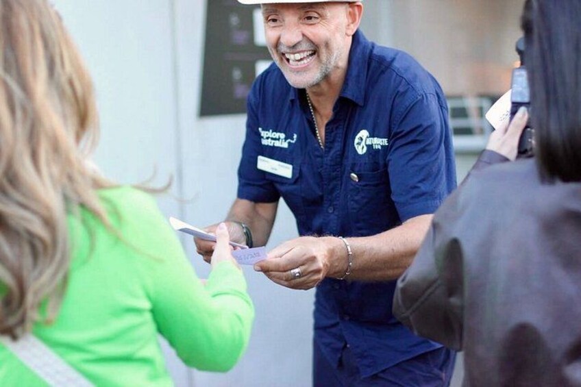 A person in a blue uniform handing over a card to another individual. 3