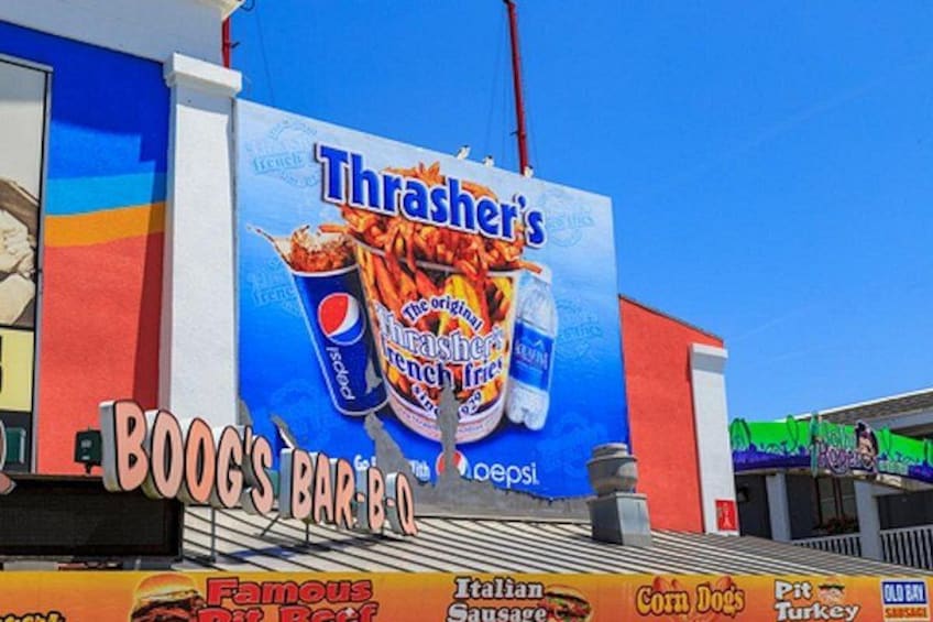 A building with a large advertisement for Thrashers' French fries and Pepsi. 3