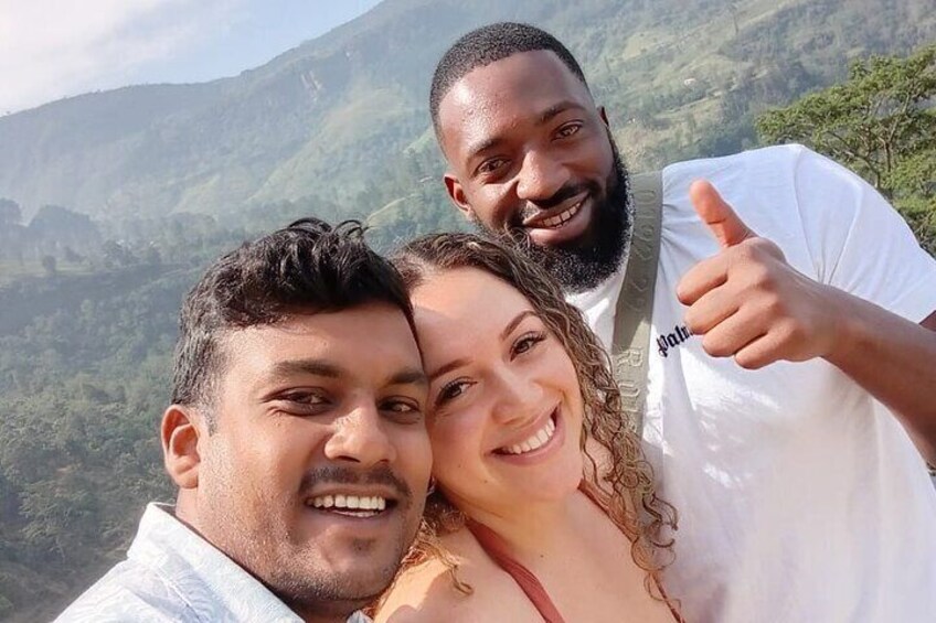 Three people taking a selfie with a mountainous landscape in the background. 3