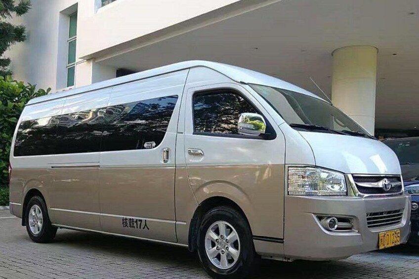 A white van parked in front of a building with a yellow license plate. 5