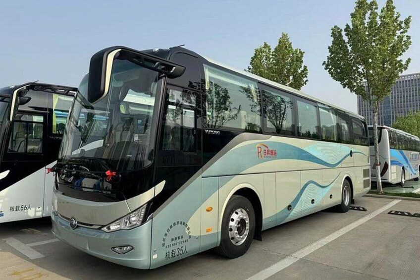 A modern bus with a sleek design, large windows, and a logo on the side. 3