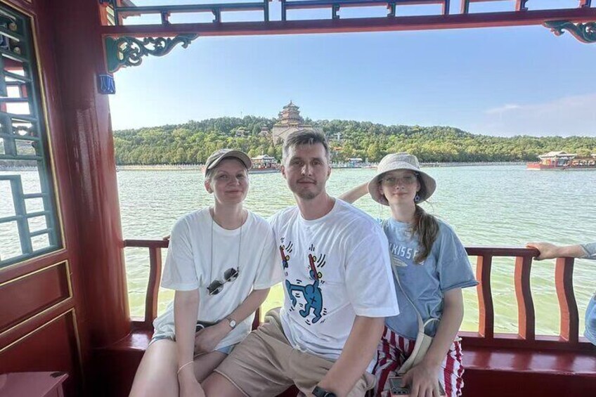 Tres personas sentadas en un bote, con un templo al fondo. 4