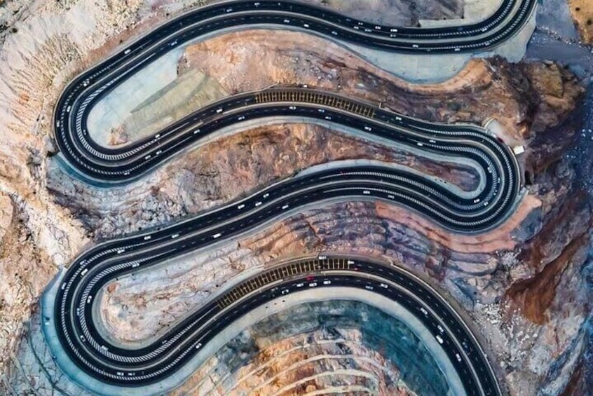A winding railway track through a rocky terrain. 5