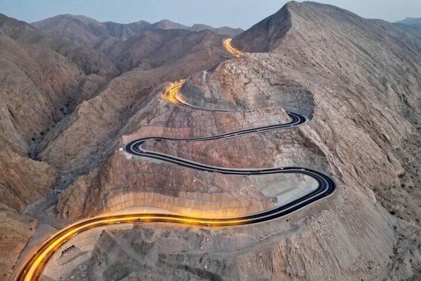 A winding road through a mountainous landscape. 1