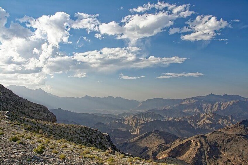 A mountainous landscape with rugged terrain and a clear sky. 3