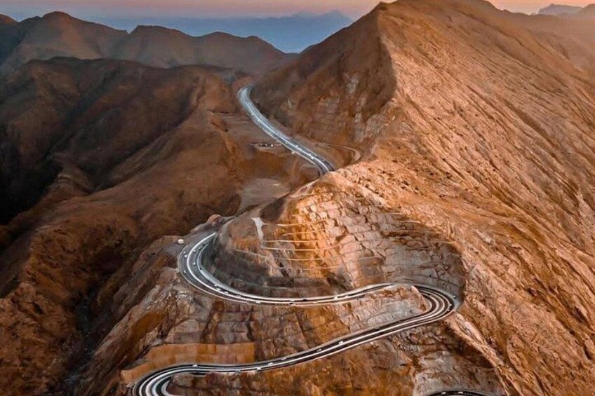A winding mountain road with multiple lanes. 4