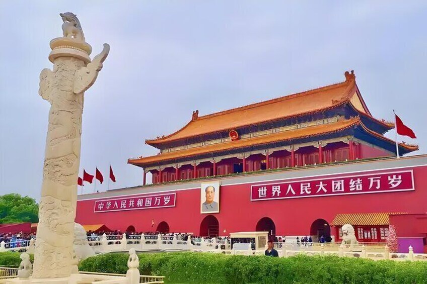 A traditional Chinese building with a red roof and a statue in front. 1