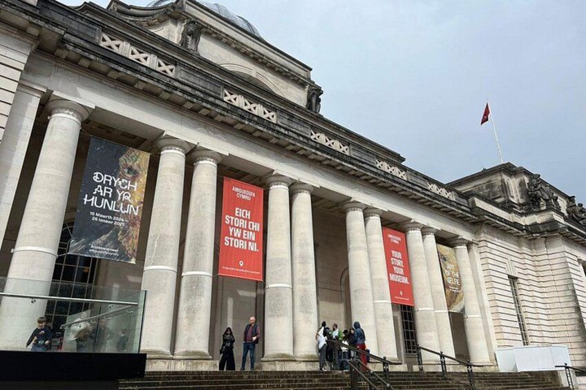 A classical building with large columns and banners. 3