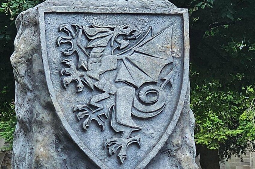 A stone shield with a crest featuring a bird and a shield. 4