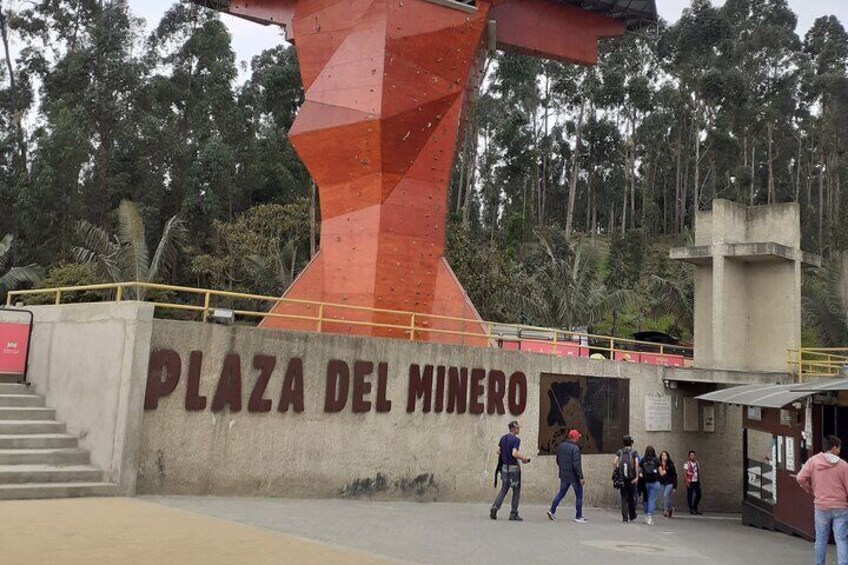 Plaza Del Minero with a large red sculpture and people walking around. 1