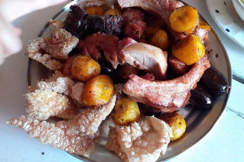 A plate of roasted meats and potatoes. 3