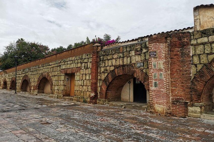 A historic stone building with arched doorways and a tiled floor. 1
