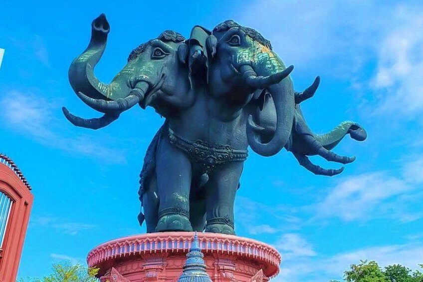 A large elephant statue on a pedestal with a clear blue sky in the background. 3