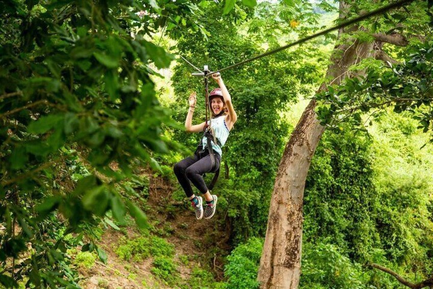 A person zip-lining through a forest. 5