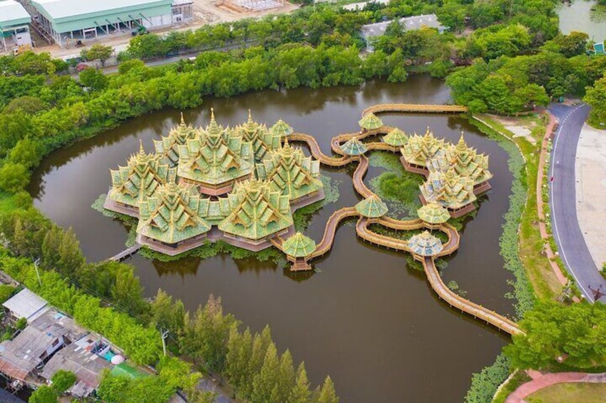 An aerial view of a temple complex with multiple pagodas surrounded by water, connected by walkways. 5