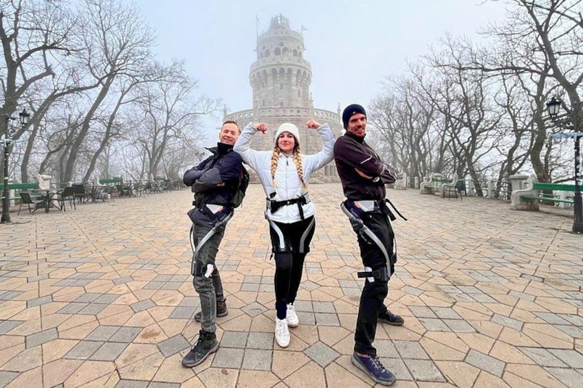 Three people posing in front of a historic building with a dome. 1