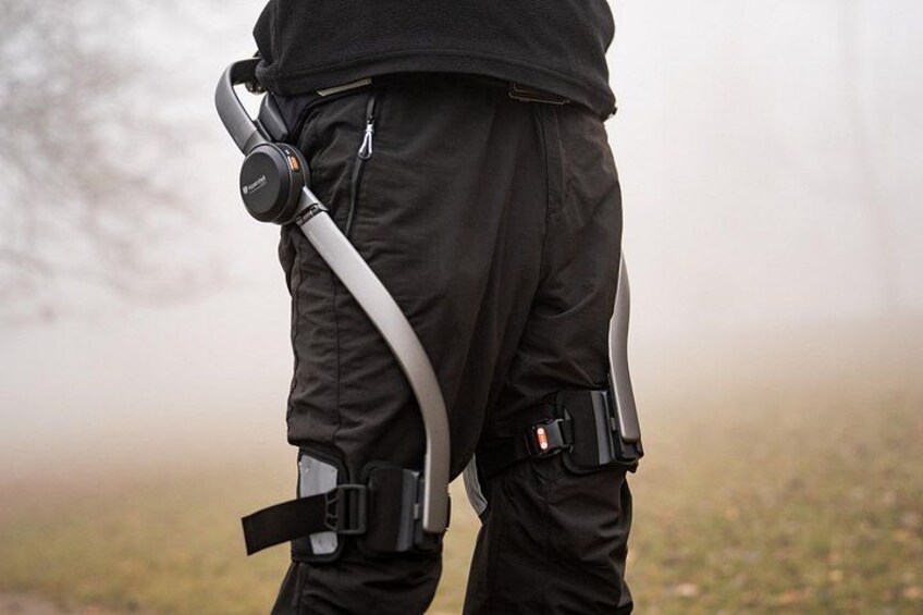 A person wearing a harness with a backpack and a gun holster. 4