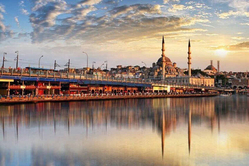 Eine Stadtansicht mit einer markanten Moschee, einer Brücke und einem ruhigen Fluss, der die Gebäude widerspiegelt. 2