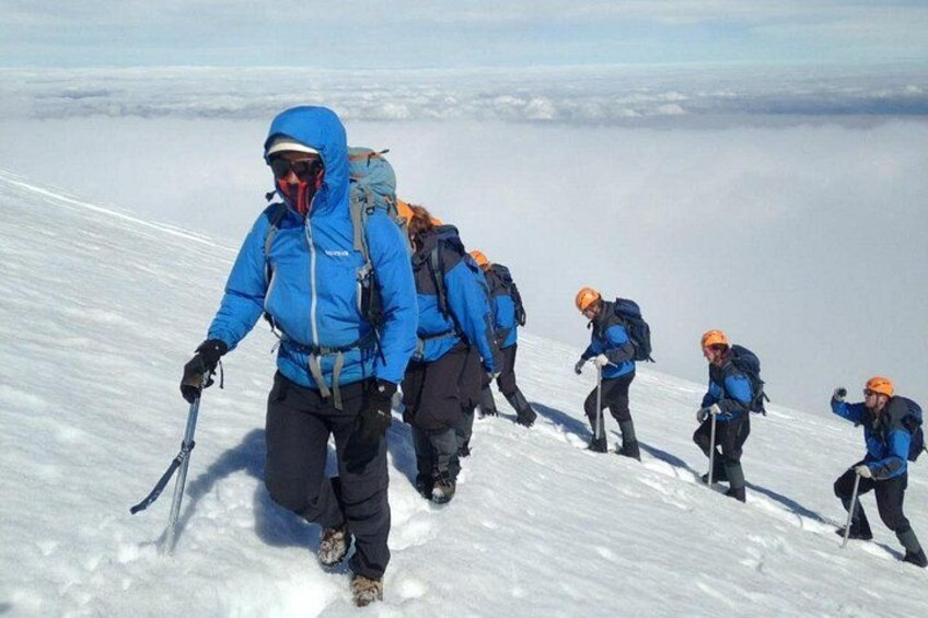 A group of hikers ascending a snowy mountain. 1