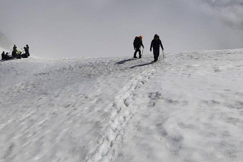 A snowy mountain landscape with hikers. 4