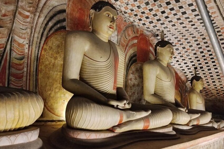 A row of seated Buddha statues in a temple. 5