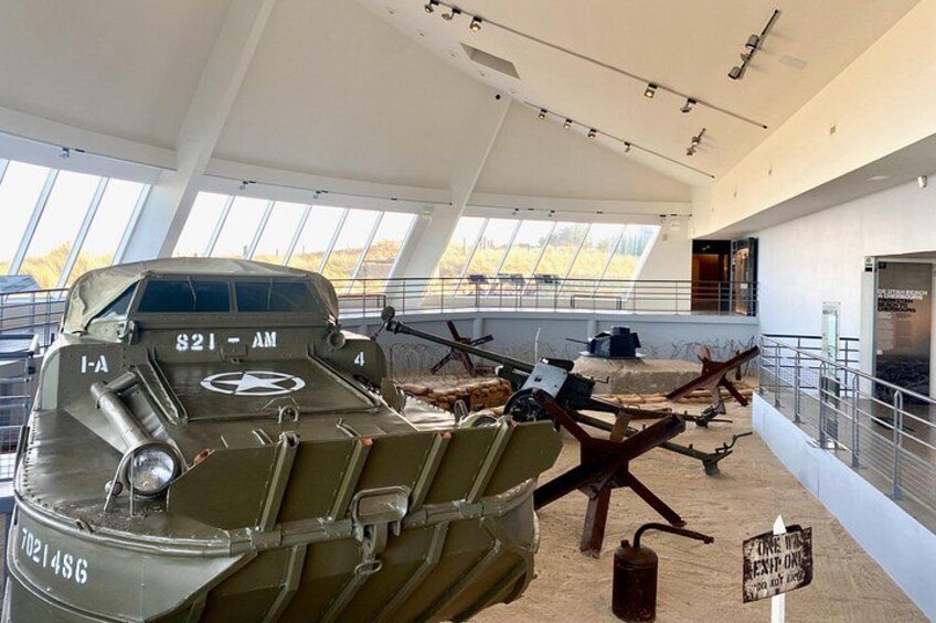 A military aircraft with the markings '821-AM' and 'I-A' displayed in a museum setting. 4