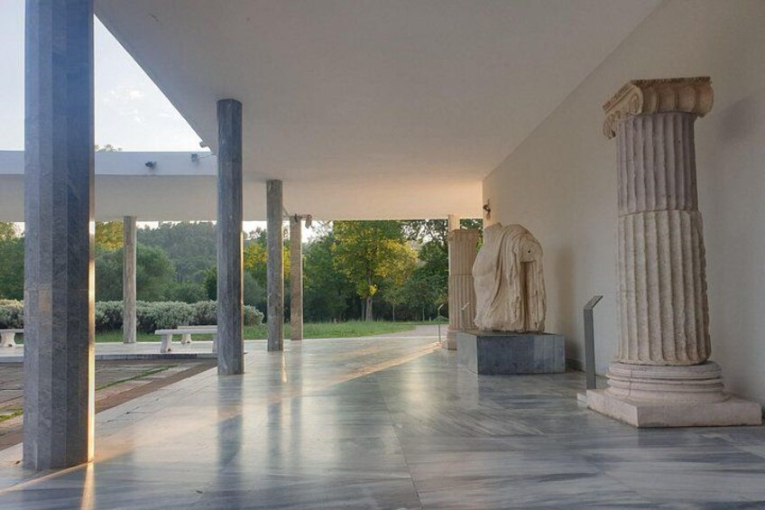 A classical architectural structure with columns and a statue. 5