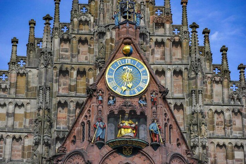 A large, ornate clock tower with intricate Gothic architecture, featuring a prominent clock face and statues. 2