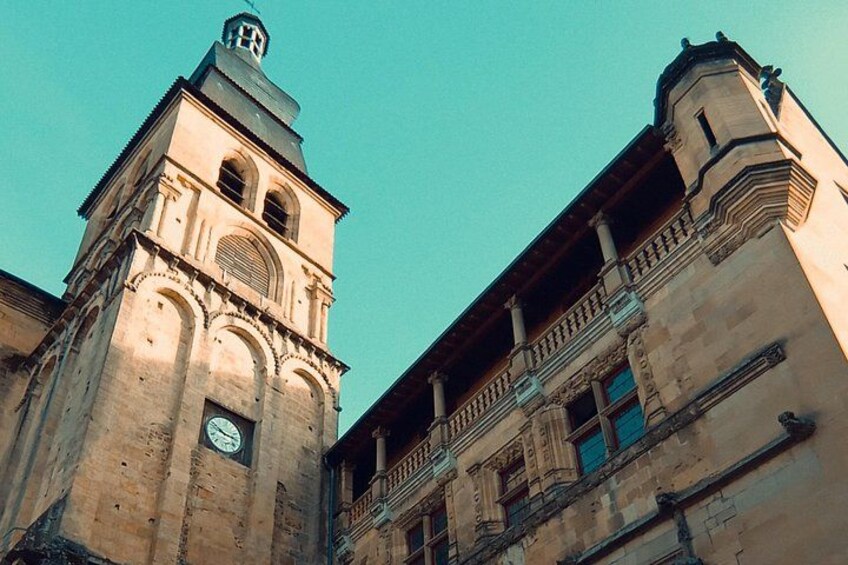 A historic building with a clock tower and a balcony. 3