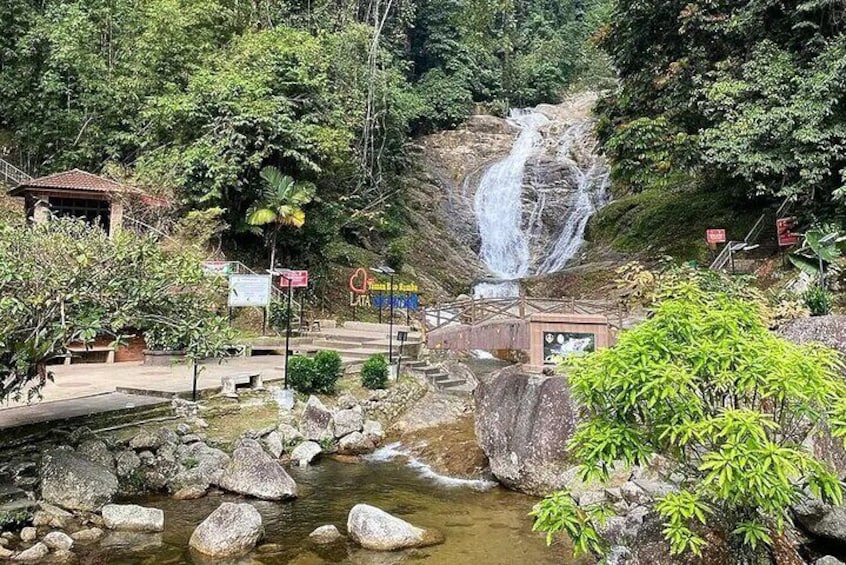 A waterfall, rocky stream, and lush greenery in a natural setting. 4