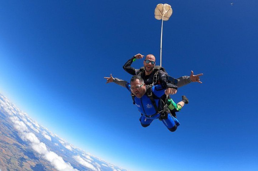 A person skydiving with a parachute. 4