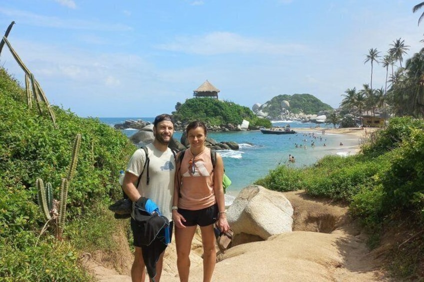 A coastal path with a beach and palm trees in the background. 3