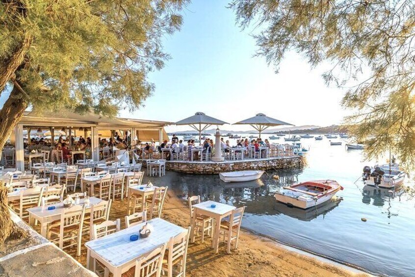 A lakeside restaurant with outdoor seating and a dock. 3
