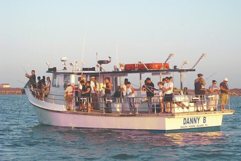 A boat named DANNY B with people fishing on board. 1