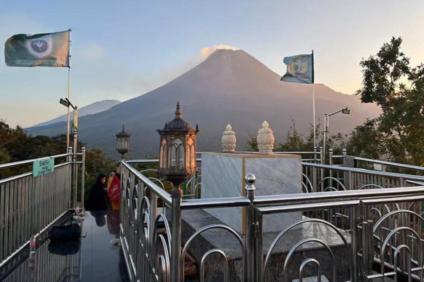 A bridge with a view of a volcano in the background. 4