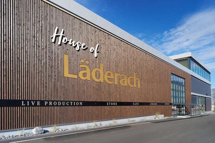 A building with a wooden facade and the text 'House of Laderach' on it. 5