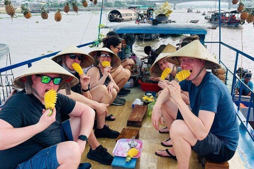 People on a boat, wearing hats, holding limes. 4