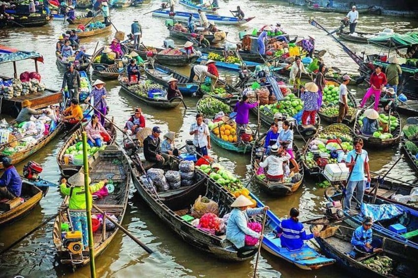 A bustling waterway with numerous boats loaded with various goods, indicating a busy trade route. 4