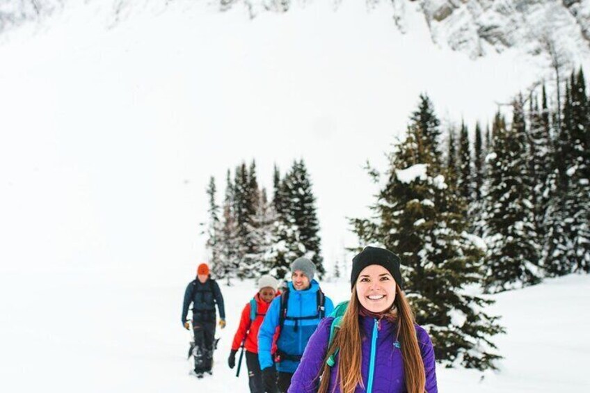 A group of people hiking in a snowy forest. 1