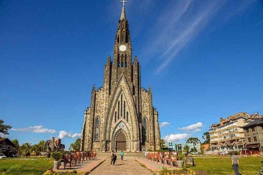 A large Gothic-style church with a tall spire and a clock tower. 2