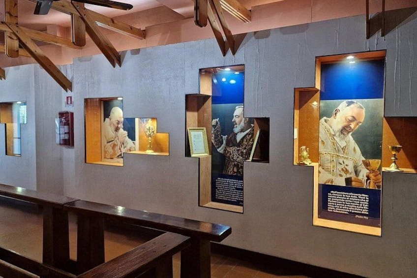 A museum exhibit with framed portraits and informational plaques. 3
