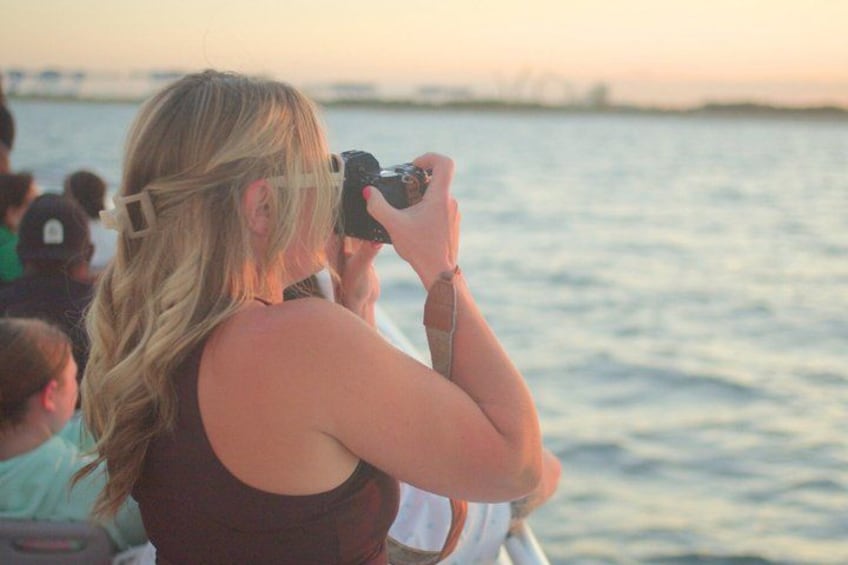 A person taking a photograph with a camera. 5